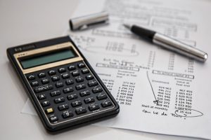 progress or recently accomplished. The image presents a physical representation of accounting, payroll management and energy-efficient practices in the construction industry.