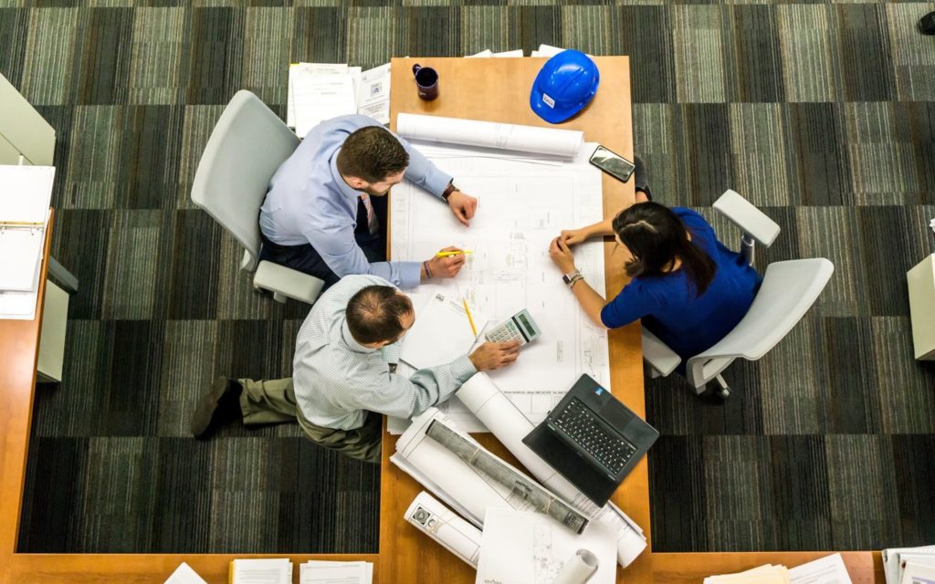 A group of people sitting at a boardroom table