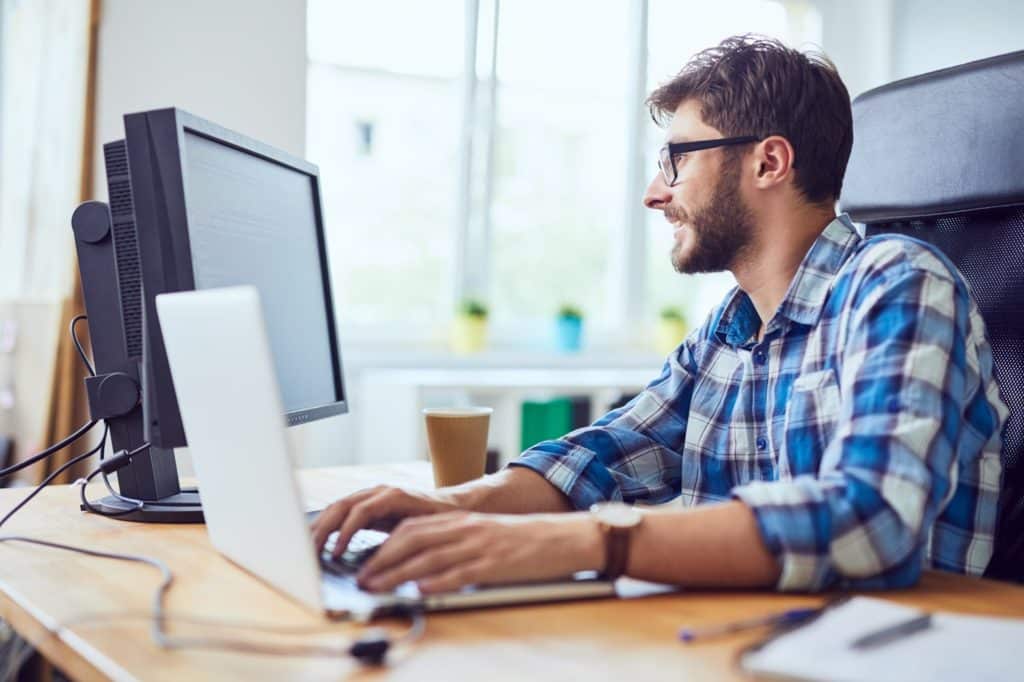 A project manager working at a computer