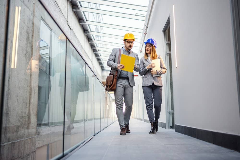 Two construction project managers looking at a tablet