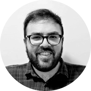 frame. The alt text, "Smiling mechanical contractor in checkered shirt and glasses," should be suitable for the image.