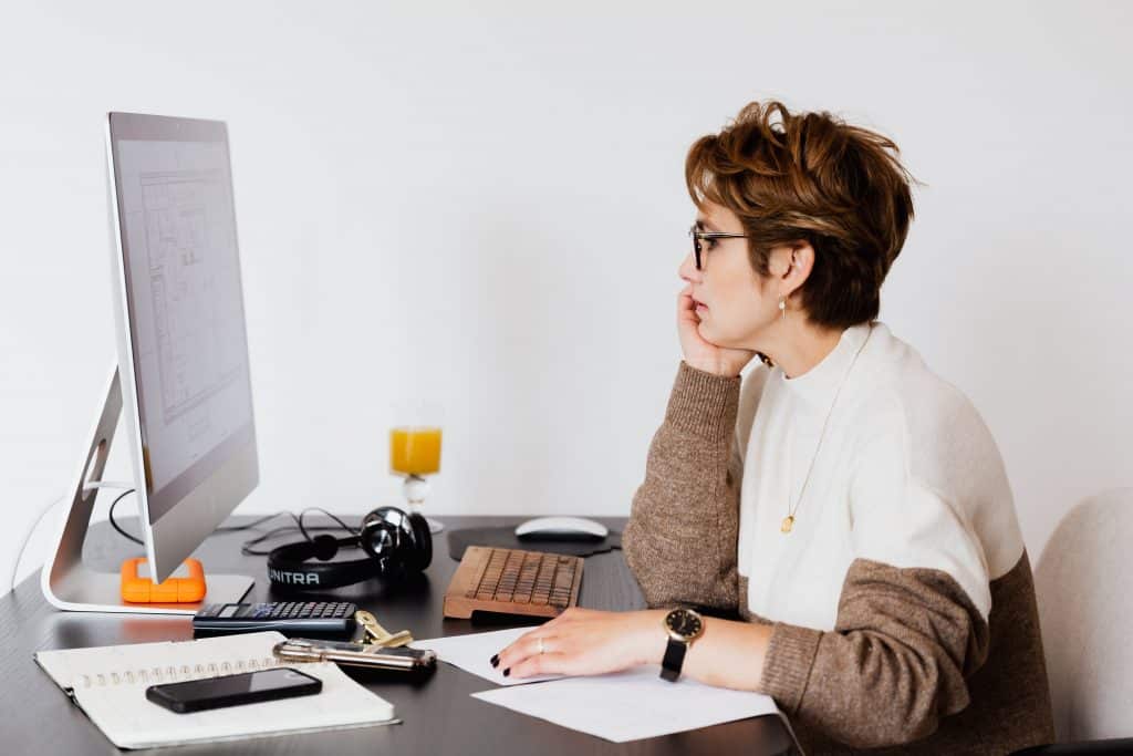 Woman looking at construction blueprint on a computer.