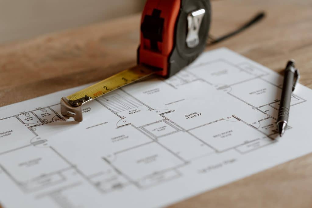 Construction blueprint with tape measure.