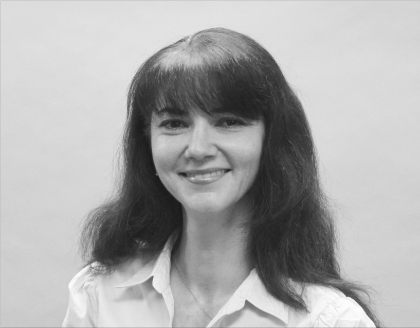 Portrait of a cheerful woman with long dark hair and light blouse, with subtle illustrations of mechanical contractors in the background.