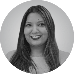 Headshot of a friendly female contractor with long, straight hair smiling in a casual top against a light background in black and white.