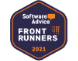 Alt text: Hexagonal badge with a dark blue background and an orange border, displaying the text "Software Advice" accompanied by an orange chat bubble. Below, it reads "FRONT RUNNERS 2021" in white and orange text. A subtle grid pattern is visible on the right side of the badge.
